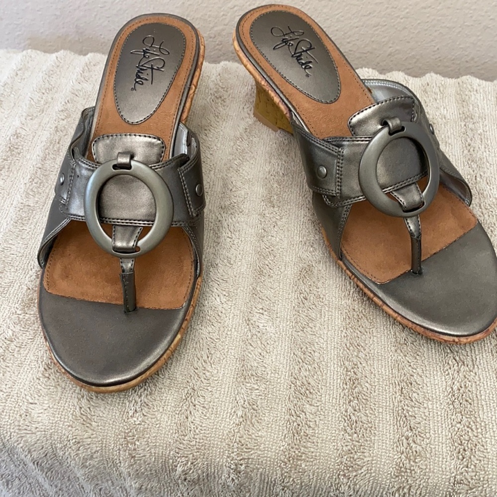 New with box, Pewter colored sandals with heel.